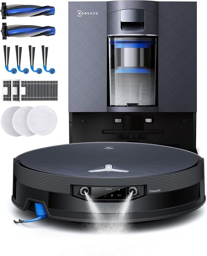 ECOVACS DEEBOT X12S OmniCyclone robot vacuum spraying water in front of its bagless docking station, shown with spare rollers, side brushes and filters