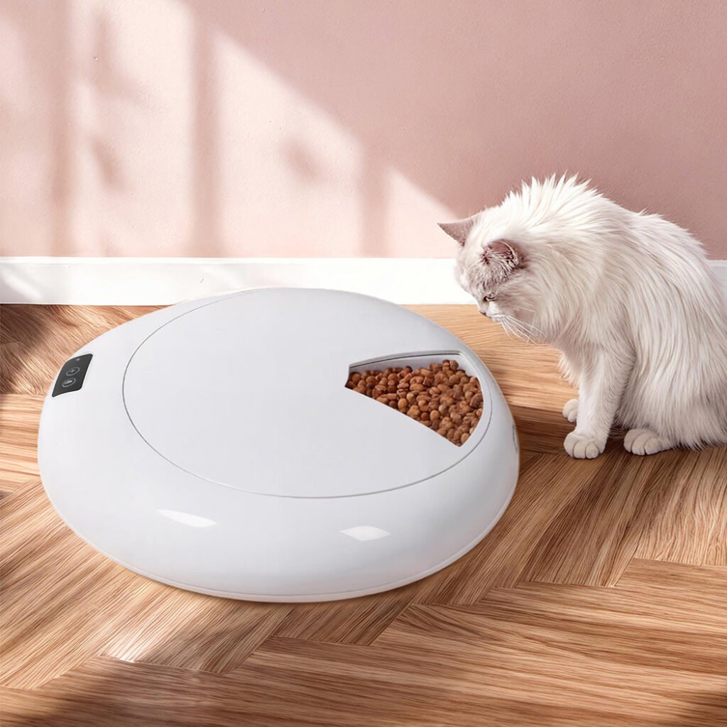 White cat eating from the open tray of the round PaWz six-meal feeder on a timber floor