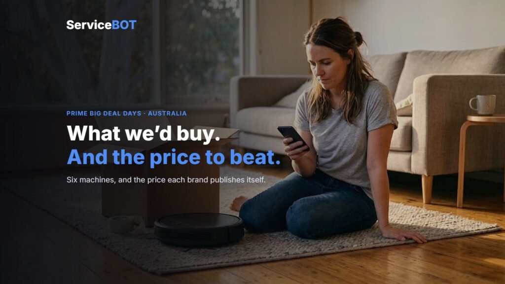 A woman sitting on a rug at home looking at her phone beside an open cardboard box and a robot vacuum