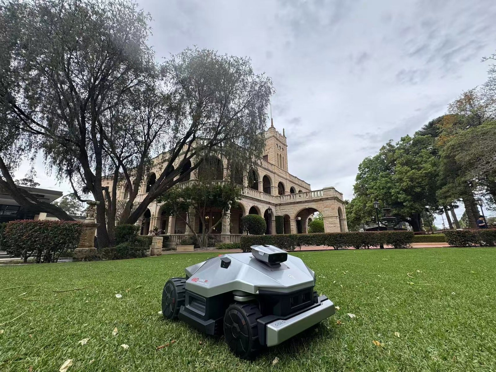 GOKO M6 robot mower on the lawn in front of Curzon Hall, Sydney
