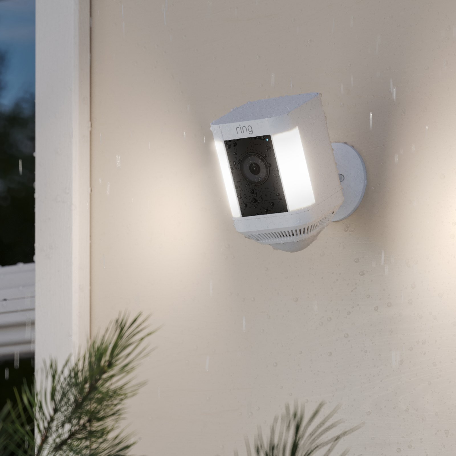 Ring Spotlight Cam Plus Battery in white, mounted outdoors